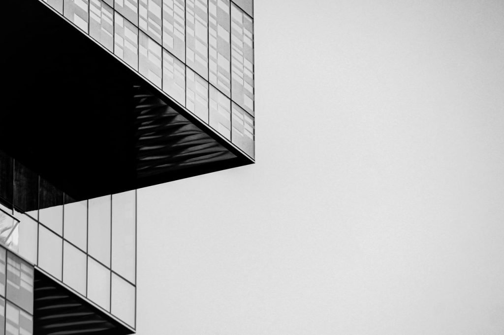 Black and white abstract shot of modern building exterior with geometric patterns.